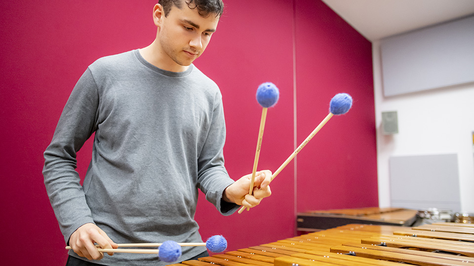 Student playing xylophone